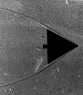 Delta wing in wind tunnel. The shadows form as the indices of refraction change within the gas as it compresses on the leading edge of this wing. Schlierenfoto Mach 17 Delta - NASA.jpg