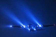 A C-130 conducts a night flight mission over Yokota Air Base A C-130 Hercules from the 36th Airlift Squadron conducts a night flight mission over Yokota Air Base (26385249024).jpg