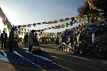 A woman worships at an aobao in Baotou, Inner Mongolia Aobao shrine worship in Baotou, Inner Mongolia.jpg