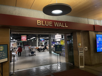 Depicts an entrance to a large dining area with the words "Blue Wall"