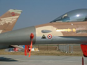 Nariz de um F-16 da Força Aérea Israelense que participou da Operação Ópera, destruindo um reator nuclear iraquiano. O cocar que representa o ataque é o triangular verde, que apresenta uma silhueta de reator nuclear contra o emblema da Força Aérea do Iraque. O outro roundel representa um avião sírio derrubado, 2004