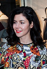 A color photograph of Welsh singer Marina Diamandis posing for a store opening event in 2014.