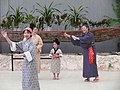 穿常服、繫腰帶跳傳統民俗舞蹈的女性