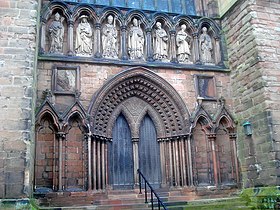 Above the ornate south doorway of Lichfield Cathedral stand seven figures carved in Roman cement. The South Door of Lichfield Cathedral - geograph.org.uk - 1640308.jpg