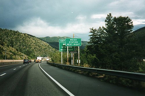 Road signs, like this one on Interstate 70 in Colorado, typically indicate that a weigh station is upcoming, and a signal indicates whether it is open.