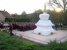 Monks praying at a stupa at Dhagpo Kagyu Ling in Saint-Leon-sur-Vezere, Dordogne. 2004-11-SortieRetraite02 004.jpg