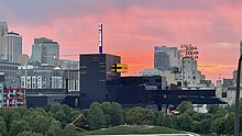 Guthrie Theater viewed from the east across Gold Medal Park at sunset, showing the scene shop at the left and the "Endless Bridge" cantilevering to the right. 2023-0902-Guthrie Theater-Sunset.jpg