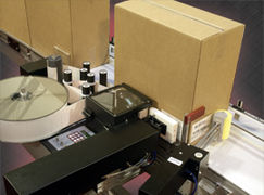 Label printer applicator applying a label to adjacent panels of a corrugated box.