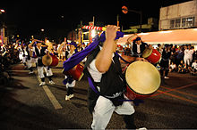 An eisa folk dancing troupe performs at night at the 2010 Okinawa International Carnival.