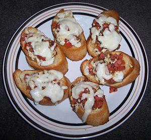 French bread topped with mozzarella cheese, to...