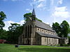 A church with an octagonal bell turret rising to a spire