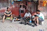 K36. A street cobbler in Delhi.