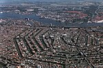 An aerial view of a cramped city, clearly spaced by hexagonal bodies of water.