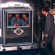 The crew of Apollo 11 in quarantine after returning to earth, visited by Richard Nixon.