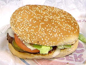A hamburger with a sesame seed roll.