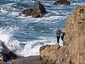 Girl standing on a rock at Glass Beach