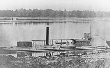 Black and white photo of a monitor with low freeboard. On the left is its single turret.