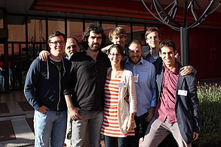 The photo shows a group of people standing outside a museum