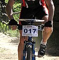 Mountain bike orienteer with a map board on bike handlebars