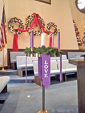 On Christmas, the Christ Candle in the center of the Advent wreath is traditionally lit in many church services. Advent Wreath (Broadway United Methodist Church).jpg