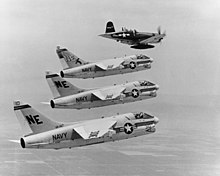 Lynn Garrison in a Chance Vought F4U-7 Corsair leads A-7 Corsair IIs of VA-147, over NAS Lemoore, California on 7 July 1967 prior to the A-7's first deployment to Vietnam on USS Ranger. The A-7A "NE-300" is the aircraft of the Air Group Commander (CAG) of Attack Carrier Air Wing 2 (CVW-2). F4U 7 AND CORSAIR 11.JPG