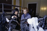 Ford and Social Secretary Maria Downs inspect centerpiece sculptures designed by Frederic Remington and Charles Russell ahead of an October 1975 state dinner honoring Anwar Sadat, the president of Egypt
