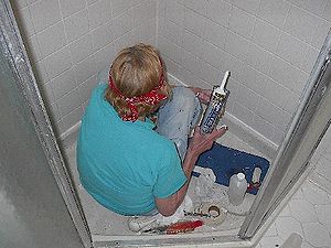 Repairing shower stall with grout applicator