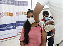 A Sri Lankan woman is vaccinated in 2021 as part of the COVAX initiative The United States Delivers COVID-19 Vaccine Doses to Sri Lanka (51776533161).jpg