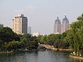 View of the boating lake in the park, with the two towers of the Global Harbor shopping mall in the distance