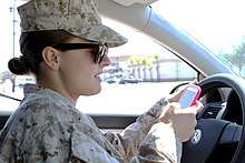 A woman texting while driving Distracted driving kills, keep your eyes and mind on the road 130417-M-RR352-002.jpg