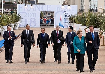 English: World leaders walk to the first worki...