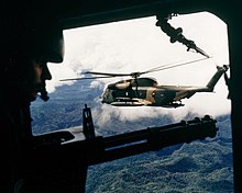 A HH-53 seen from the gunner's position of a helicopter over Vietnam in October 1972 HH-53C over Vietnam October 1972.jpg