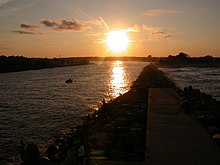 The Jersey Shore extends inland from the Atlantic Ocean into its many inlets, including Manasquan Inlet, looking westward at sunset from the jetty at Manasquan. ManaInlet II.JPG