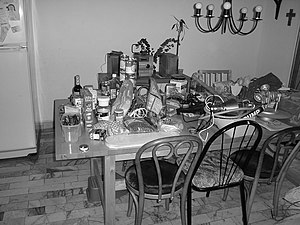 Photo of a dining room table piled with objects