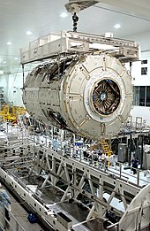 Node 2 being hoisted by overhead cranes in the Space Station Processing Facility SSPF interior.jpg