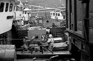 Unloading fish on the fishing boat "Silvery Sea" in Mallaig harbour, Scotland, in 1977. This boat sank with all hands lost after a collision off the Danish coast in 1998. Unloading fish A, Mallaig, Sep 1977.jpg