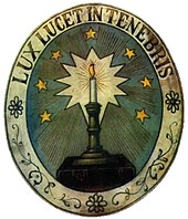 Waldensian symbol Lux lucet in tenebris ("Light glows in the darkness") Waldenser-Wappen.jpg