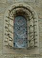 Stone window surround decorated with insects, birds and pinecones at St Mary's, Wreay