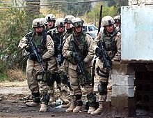 Members of the regiment waiting to dash across a street in Baghdad, Iraq, as part of their mission there searching for suspected militants. 82ndinBaghdad.jpg