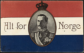 Postkort fra 1906 med portrett av kong Haakon VII og valgspråket «Alt for Norge» på en bakgrunn av de norske fargene. Foto: Nasjonalbiblioteket