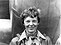 Amelia Earhart standing under nose of her Lockheed Model 10-E Electra, small.jpg