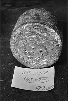 A uranium metal "biscuit" created from the reduction reaction of the Ames process. Ames Process uranium biscuit.jpg