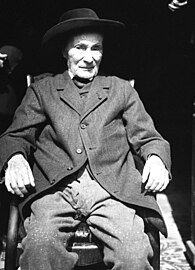 Jean-Henri Fabre assis dans l'entrée de sa maison en 1914.