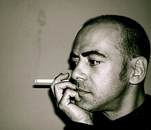 Black-and-white photo of Unzueta with a cigarette