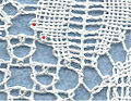 Torchon lace: two pins (red dots) connect two pairs of the ground with the motif