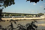 From the south bank, downstream of the bridges and dam