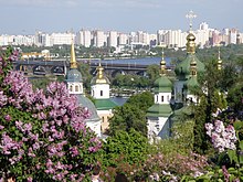 Lilacs in the National Botanical Garden, with the Vydubychi Monastery, Darnytskyi Rail Bridge and left-bank Kyiv visible in the background Vydubychi Monastery 2008(Kiev).JPG