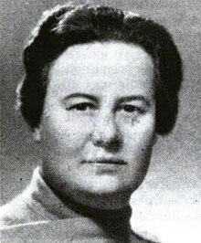 A black and white photograph of a white woman with short, dark hair.