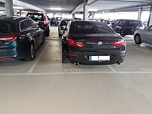 Car occupying two parking spaces, often frowned upon in many countries Bad car parking.jpg