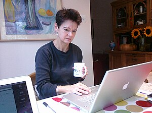 Diane Coyle working with Apple laptop on 9 Oct...